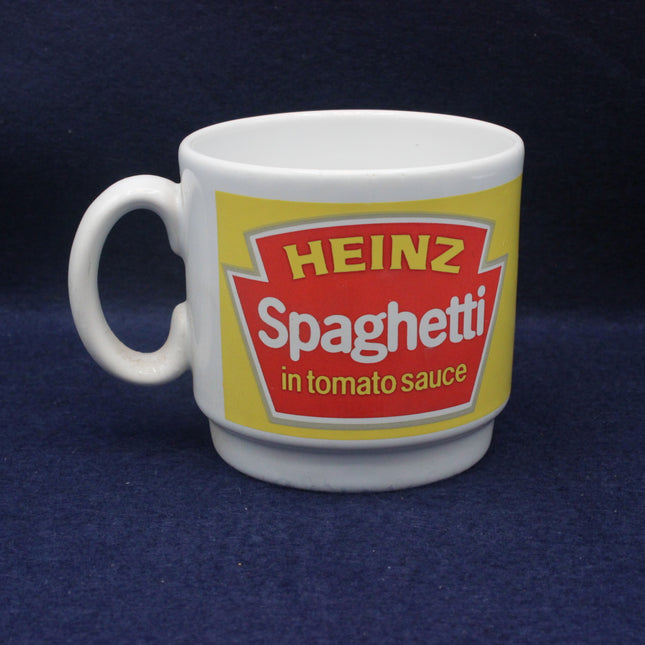 White mug with Heinz Spaghetti in tomato sauce label on a dark blue background