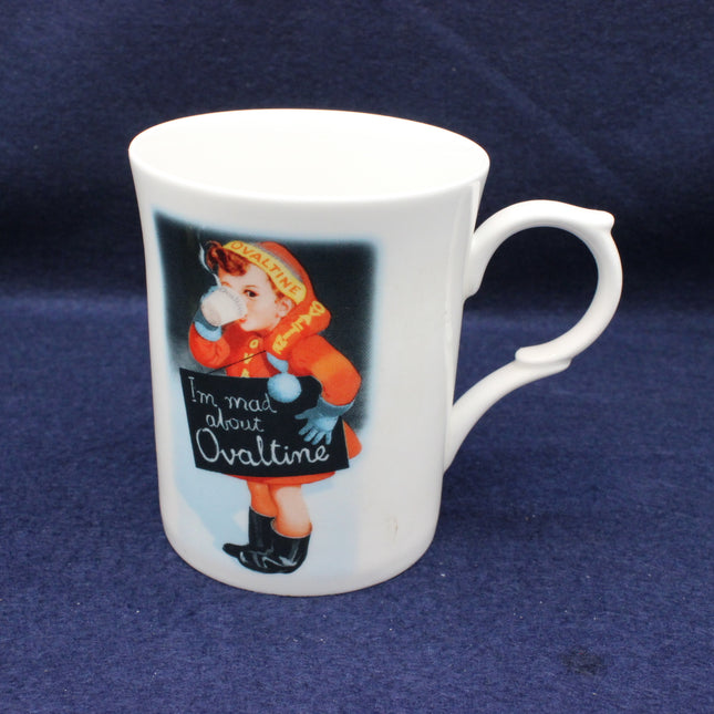 White mug with vintage illustration of a child and 'I'm mad about Ovaltine' text on a blue background
