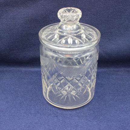 Clear glass jar with a lid on a blue background