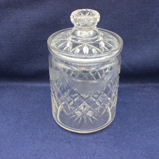 Clear glass jar with a lid on a blue background