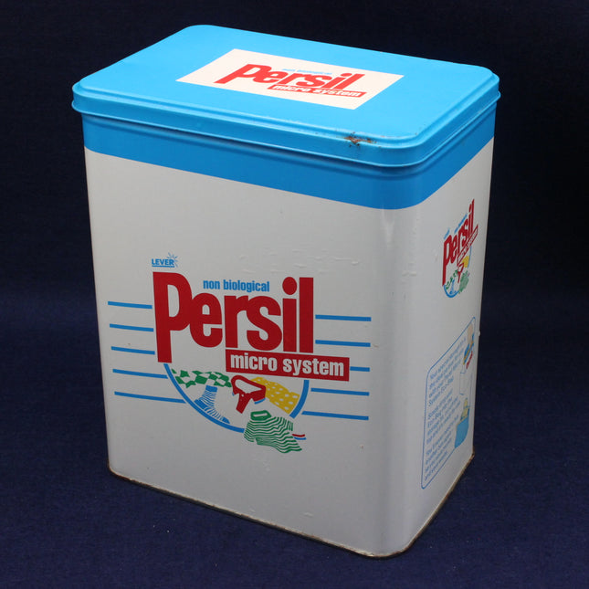Vintage Persil laundry detergent container with blue lid on a dark background