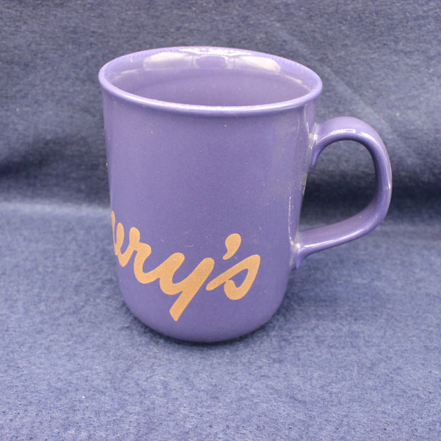 Purple mug with 'Cadbury's' text on a grey background