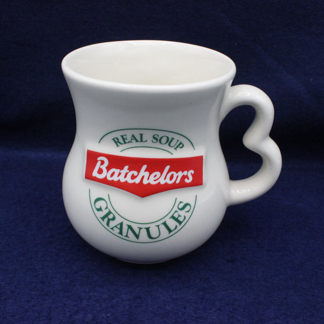 White mug with Batchelors soup granules branding on a dark blue background