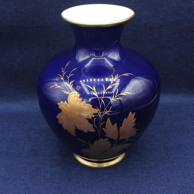 Blue vase with gold floral patterns on a blue background