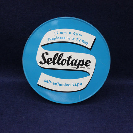 Blue container of Sellotape with white label on a dark blue background