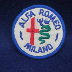 Alfa Romeo Milano logo patch on a dark blue background