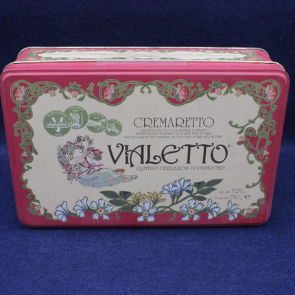 Vintage-style pink and green tin box with floral design and 'VIALETTI' branding on a blue background.