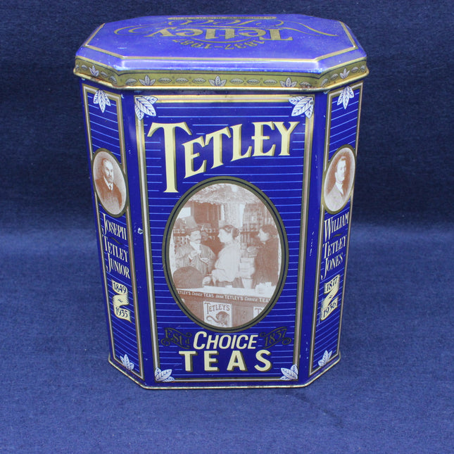 Blue Tetley tea tin with historical images on a blue background