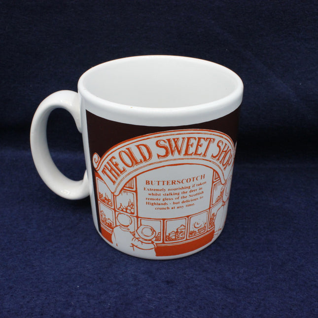 White mug with orange and brown design on a blue background