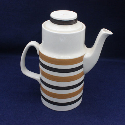 White ceramic teapot with brown and black striped design on a blue background