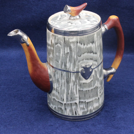 Teapot with wooden handle and lid knob on a blue background