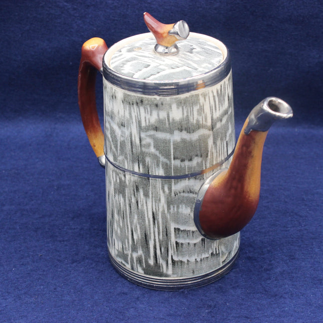 Ceramic teapot with abstract design on a blue background