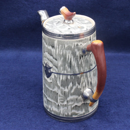 Decorative teapot with a textured design on a blue background