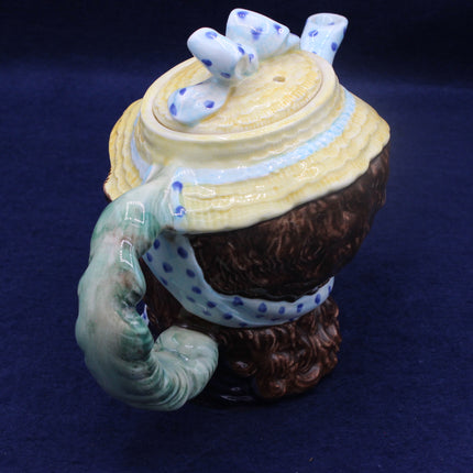 Womans Face teapot on a dark blue background
