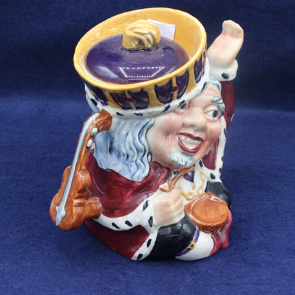 Decorative ceramic figure of a jester with a purple hat on a blue background