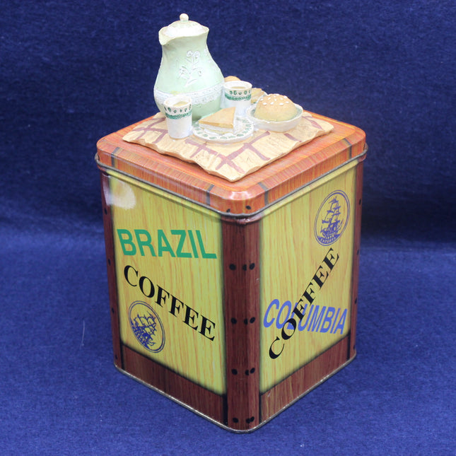 Decorative coffee tin with miniature coffee set on a blue background