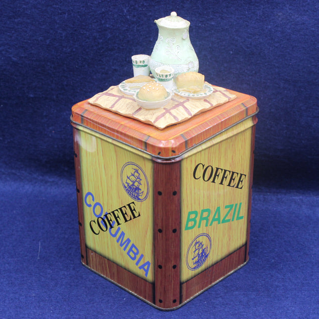 Decorative coffee canister with 'Coffee Brazil' and 'Coffee Columbia' text on a blue background