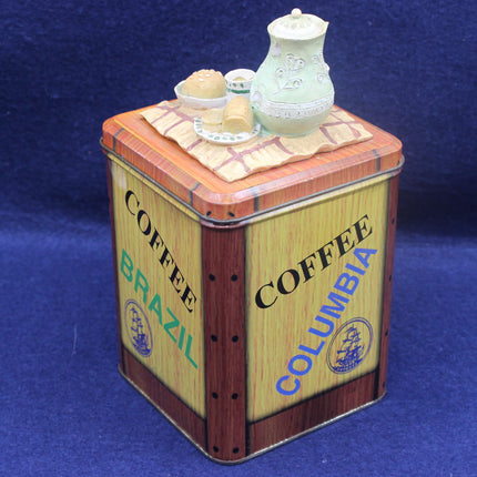 Decorative coffee canister with 'Coffee Brazil' and 'Coffee Columbia' text on a blue background
