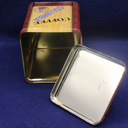 Gold coffee tin with wooden lid on a blue background