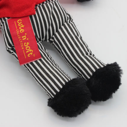 A close-up of a plush Golly doll's striped pants with black fluffy cuffs and a red tag that reads 'cute 'n soft COLLECTION'.