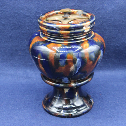 Decorative ceramic j with multicolored design on a blue backgroundr