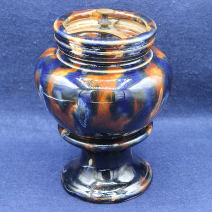 Decorative urn with multicolored design on a blue background