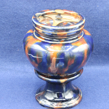 Colorful ceramic urn on a blue background