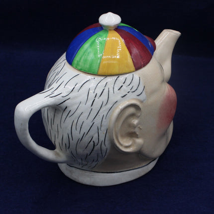 Vintage Devonmoor Character Teapot  Hand‑Painted British Pottery on a blue background