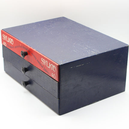 A vintage Sylko 40mm drawer box set, featuring a dark navy blue wooden box with three drawers pulled out, showing a red front label with white Sylko branding.