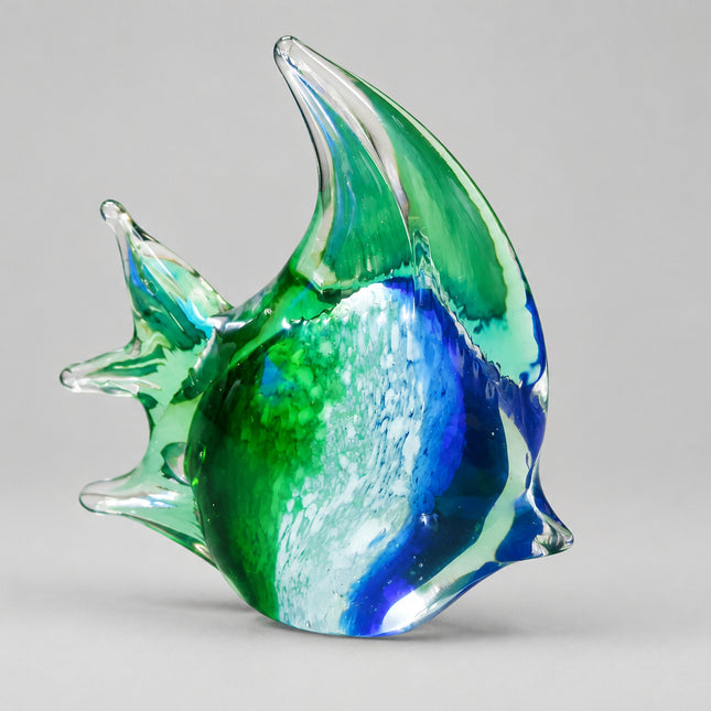 A hand-blown glass fish figurine with blue, green, and white swirls, set against a solid green background.