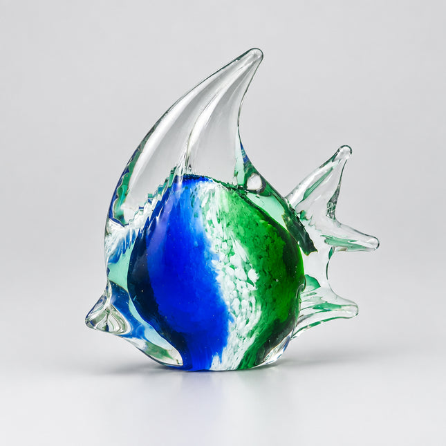 A hand-blown glass fish figurine with a blue and green marbled pattern inside clear glass, set against a solid green background.