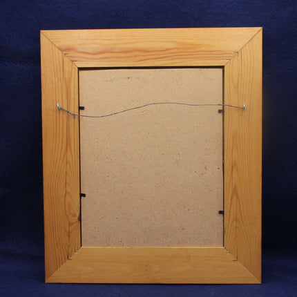 Back view of a wooden picture frame on a blue background