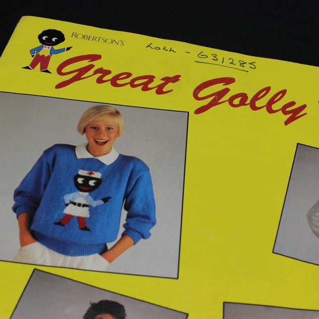 Vintage knitting pattern book cover featuring a person wearing a blue sweater with a character design, on a yellow background.