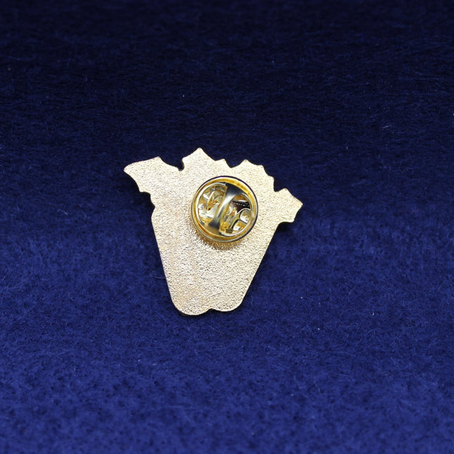 Guiness Pin with a gold center and white outline on a blue textured background