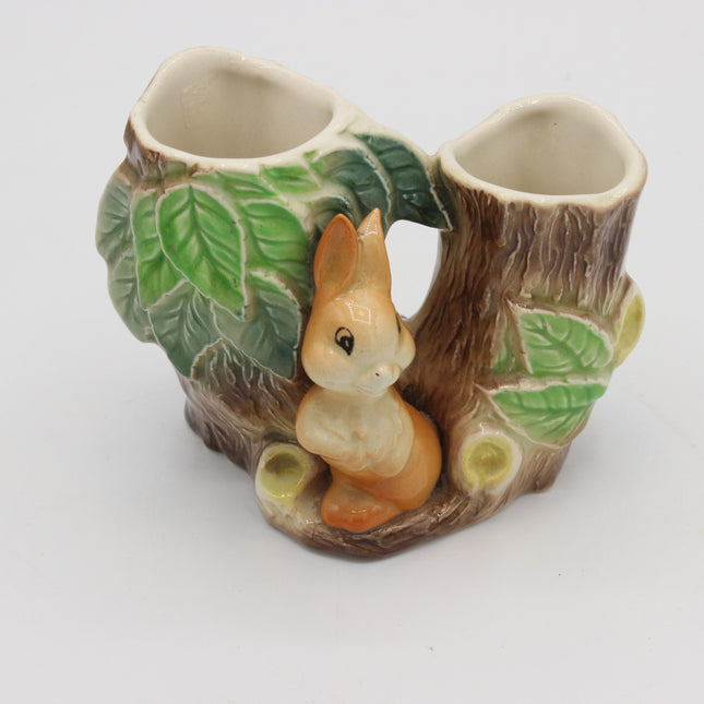 A ceramic Hornsea Pottery vase with a tree trunk with green leaves and a small orange-and-white rabbit figurine in the center, shown on a plain white background.