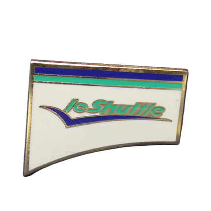 Pin with 'Le Stuttle' branding on a dark blue textured background
