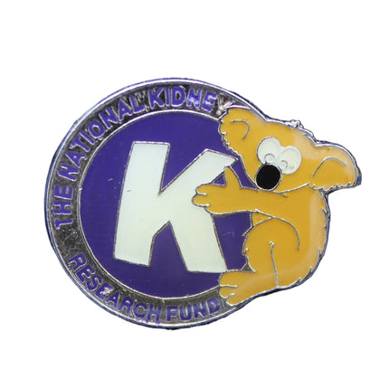 Pin with a logo featuring a mouse and a large 'K' on a blue background