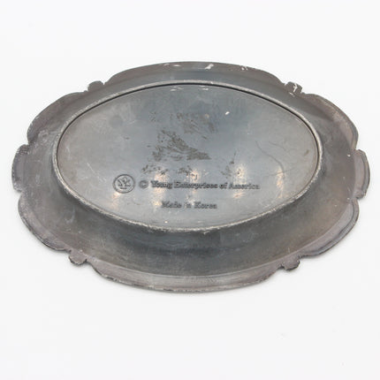 An antique oval metal serving platter with a scalloped rim, shown from a top-down perspective on a white background. The center features engraved text reading 'Young Enterprise of America' and 'Made in Korea'.