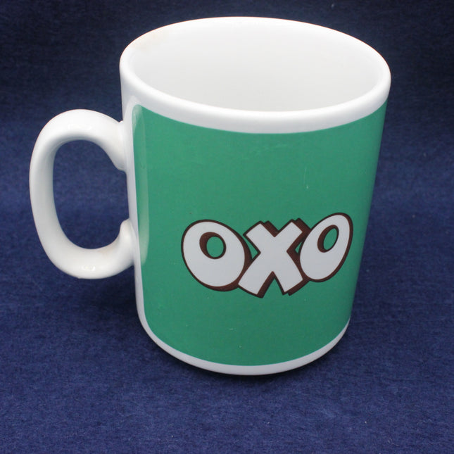 Green mug with 'OXO' logo on a blue background