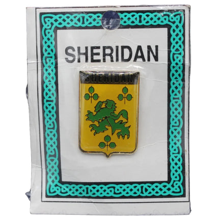 Pin with a green lion emblem on a yellow shield, branded 'Sheridan', on a blue textured background.