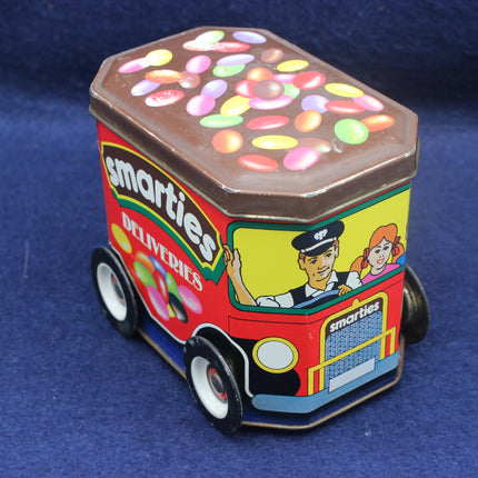 Smarties candy delivery truck tin on a blue background