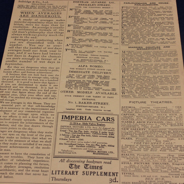 Vintage newspaper with text and advertisements on a dark surface