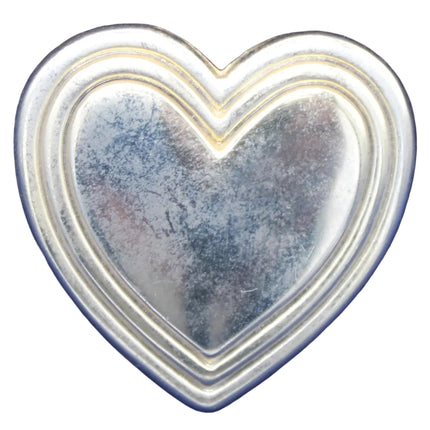 Heart-shaped metal object on a blue textured background