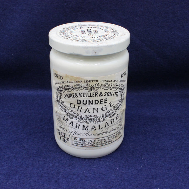 White jar of Dundee Orange Marmalade with a black label on a blue background