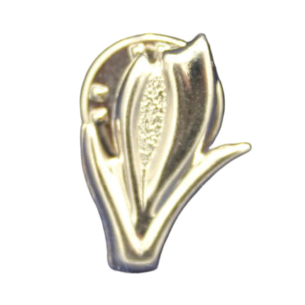 Silver leaf-shaped pin on a textured blue background