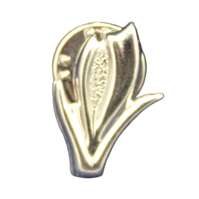 Silver leaf-shaped pin on a textured blue background