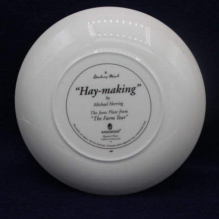 White Wedgwood plate with 'Hay-making' text on a black background