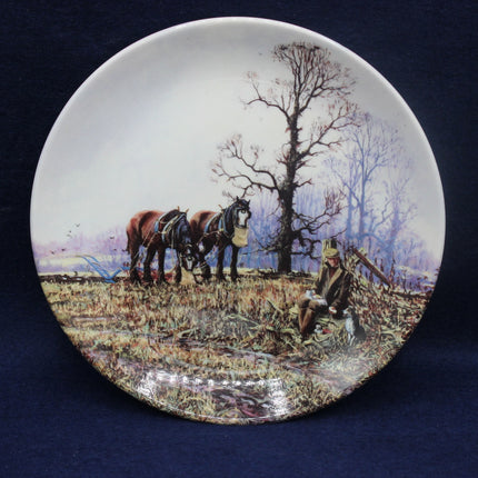 Decorative plate with a rural scene of horses and a person on a blue background