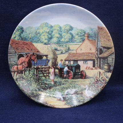 Decorative plate with a rural scene featuring a horse, people, and farm animals on a blue background.