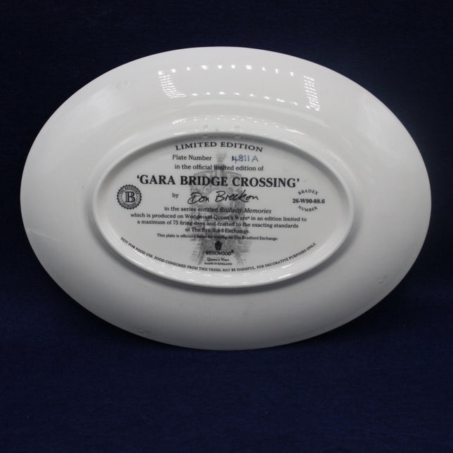 White plate with text and branding on a dark background